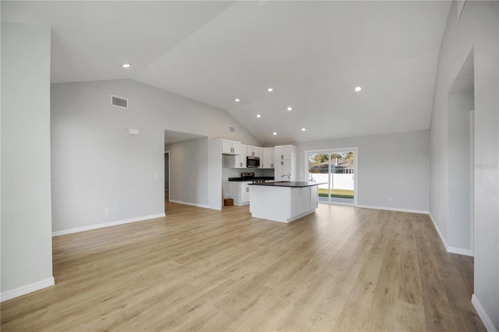 3294 West Price Boulevard North Port, FL 34286 - Photo 3 of 47 a view of kitchen with kitchen island and stainless steel appliances with wooden floor