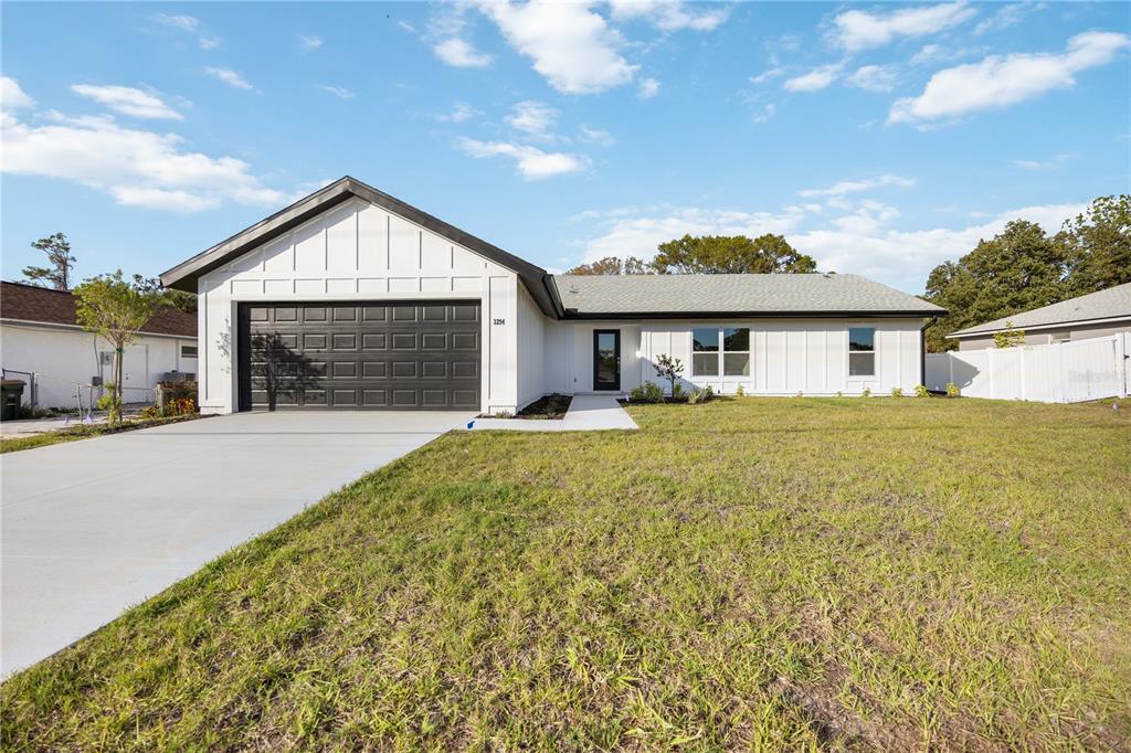 3294 West Price Boulevard North Port, FL 34286 - Photo 32 of 47 a front view of a house with a yard and garage
