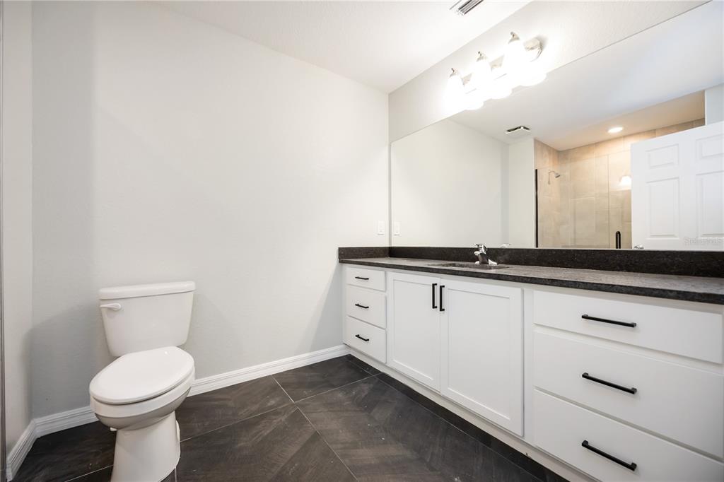 3294 West Price Boulevard North Port, FL 34286 - Photo 5 of 47 a bathroom with a toilet a sink and mirror