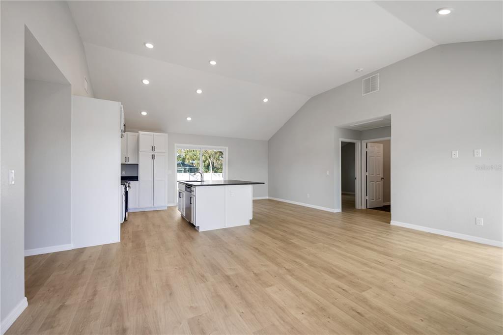 3294 West Price Boulevard North Port, FL 34286 - Photo 10 of 47 a view of a big room with wooden floor and windows