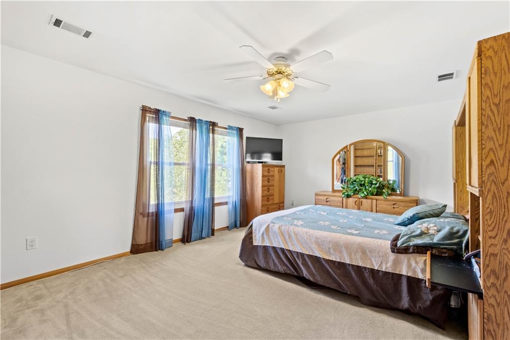 119 Cooper Road Slippery Rock, PA 16057 - Photo 17 of 25 a bedroom with a bed and a chandelier