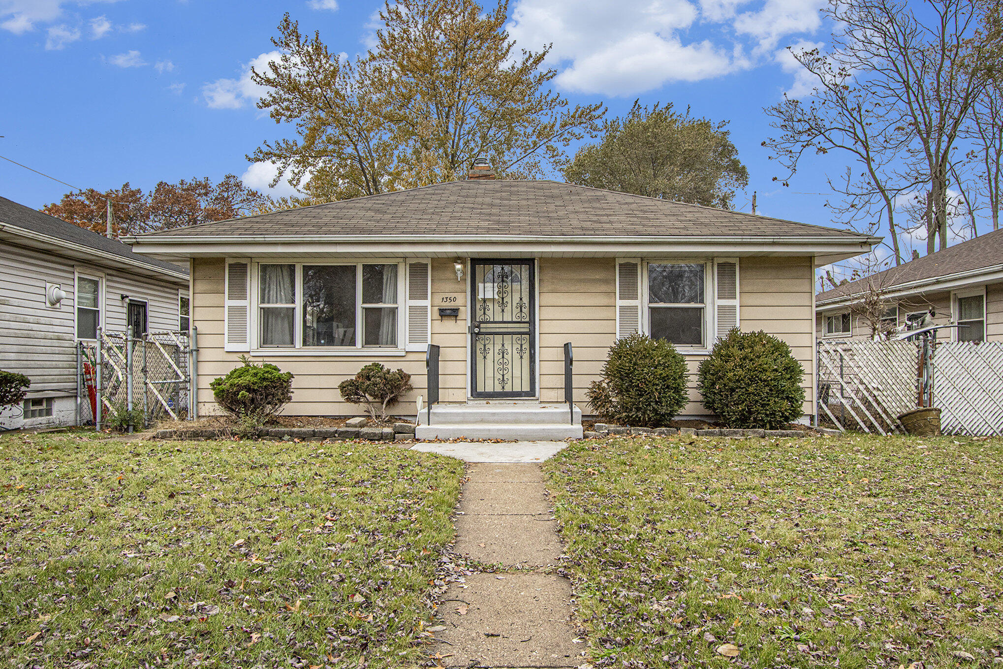 1350 Morton Street Gary, IN 46404 - Photo 3 of 17 a front view of a house with garden