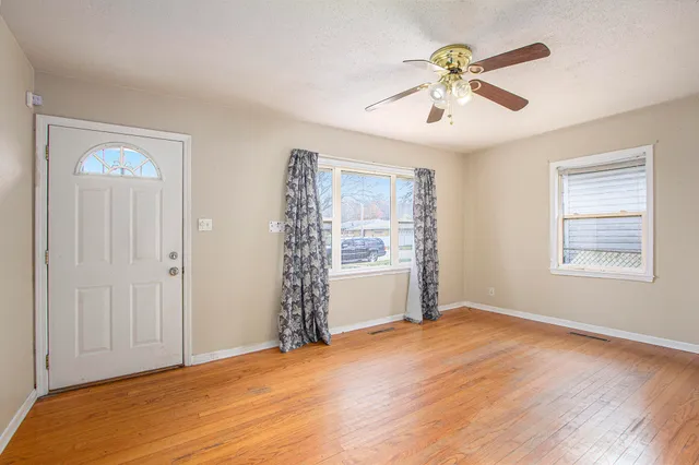 wooden floor in an empty room with a window