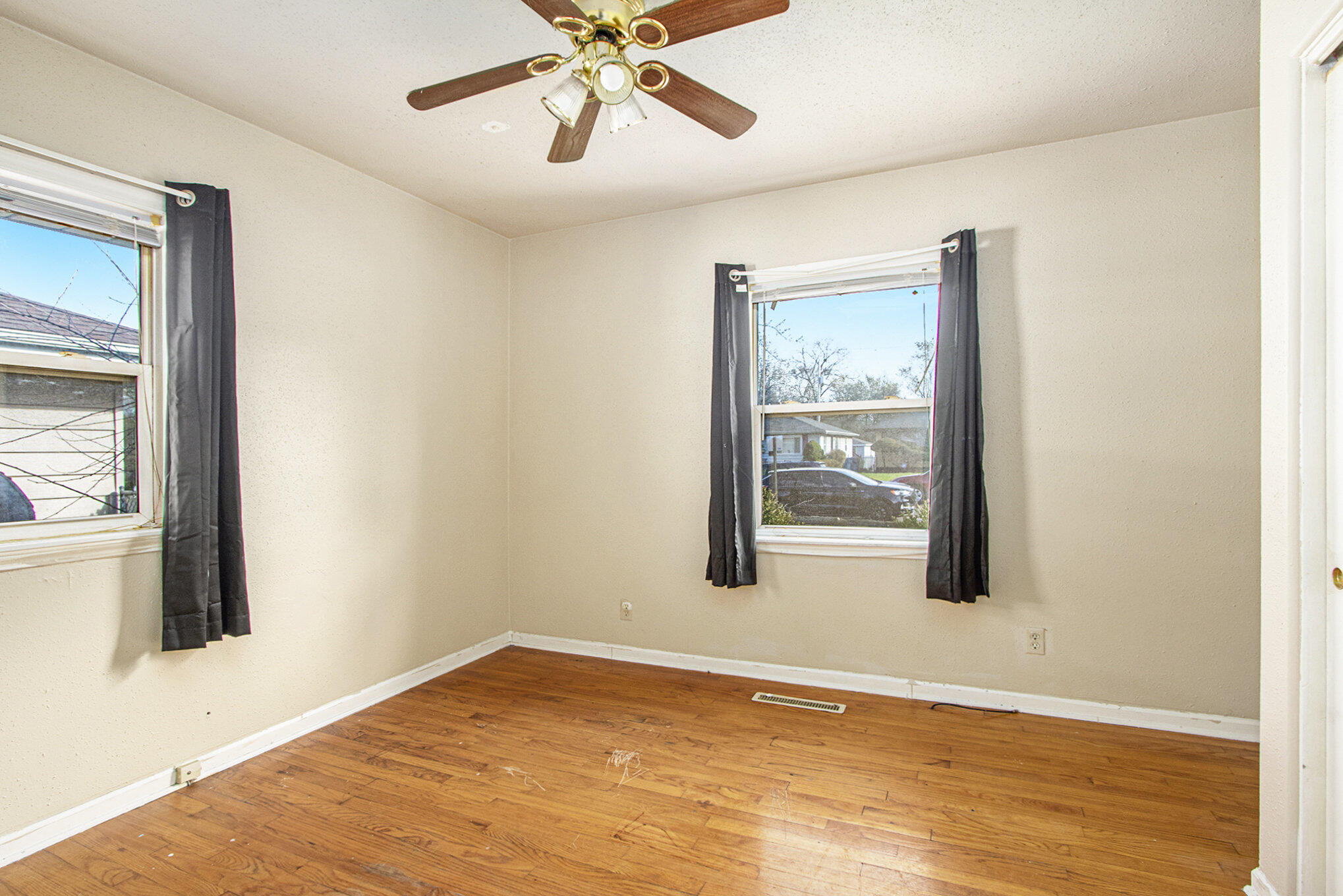 1350 Morton Street Gary, IN 46404 - Photo 10 of 17 a view of an empty room with wooden floor and a window