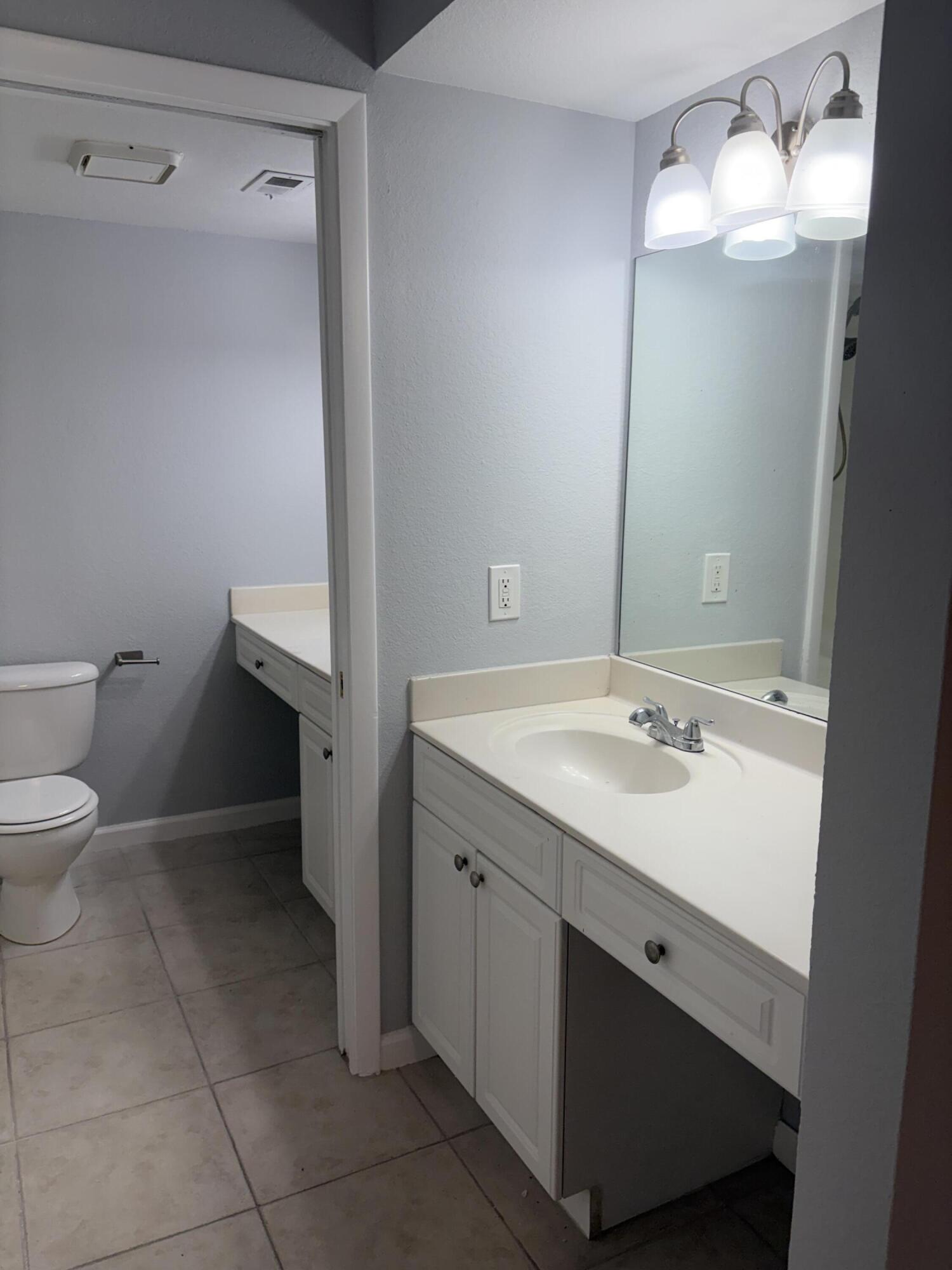 8165 Severn Drive, Unit D Boca Raton, FL 33433 - Photo 11 of 14 a bathroom with a sink vanity and toilet