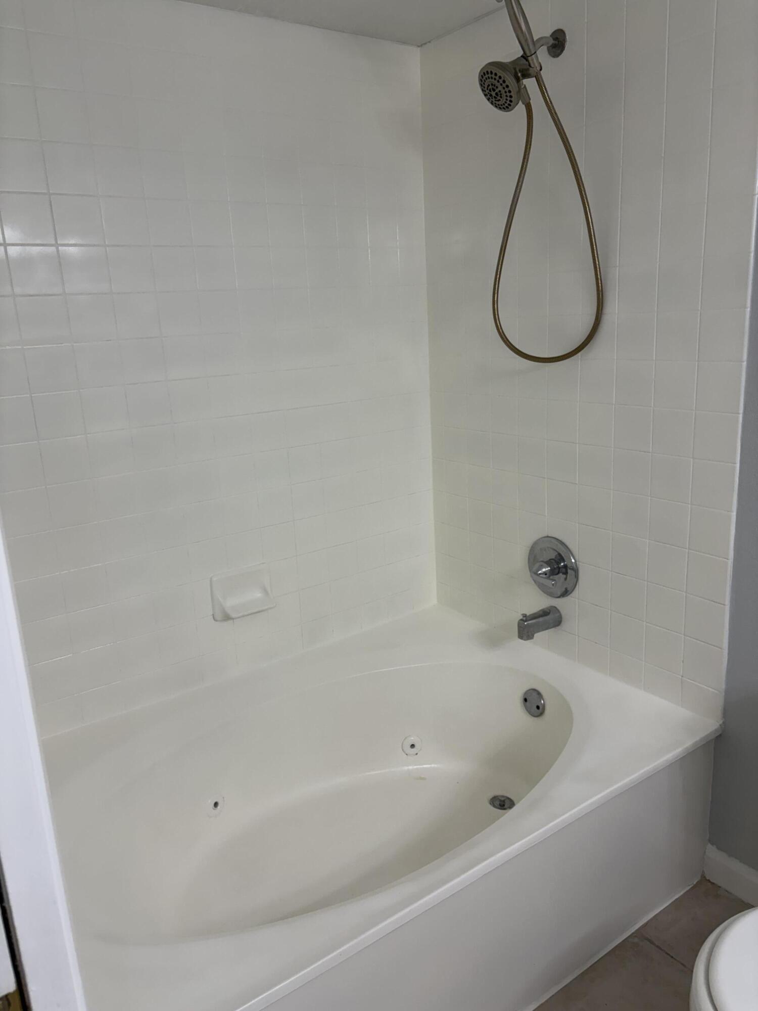 8165 Severn Drive, Unit D Boca Raton, FL 33433 - Photo 14 of 14 a bathroom with a bath tub and a shower