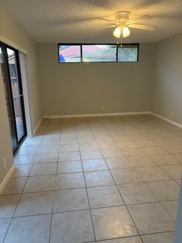 a view of a livingroom with an empty space and a window
