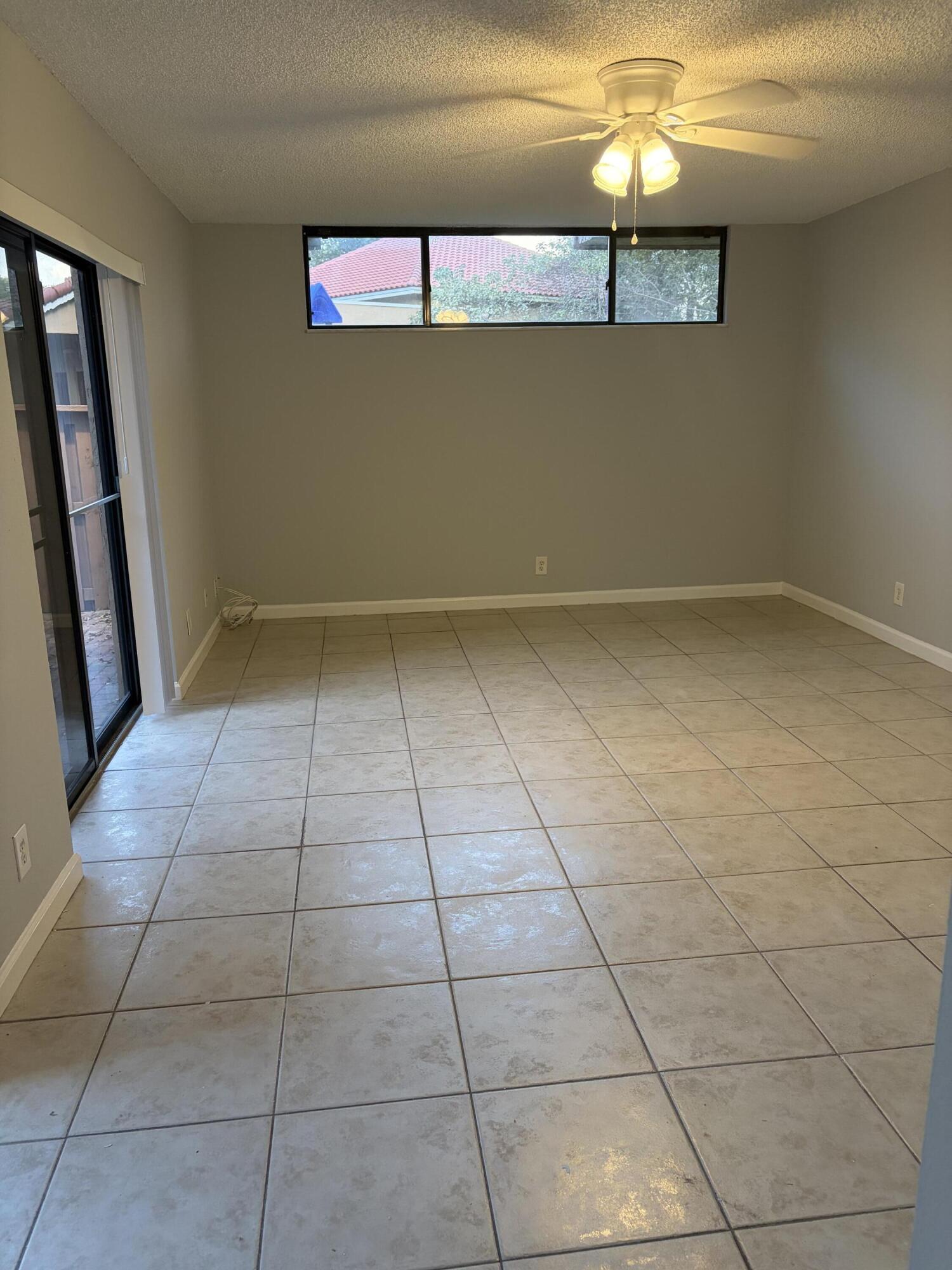 8165 Severn Drive, Unit D Boca Raton, FL 33433 - Photo 3 of 14 a view of a livingroom with an empty space and a window