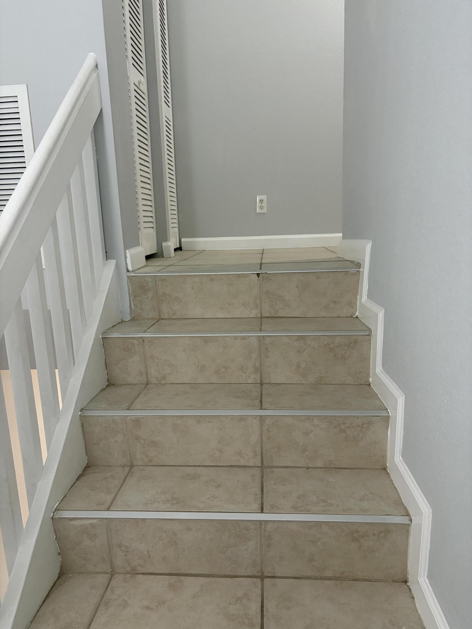 8165 Severn Drive, Unit D Boca Raton, FL 33433 - Photo 5 of 14 a view of staircase with white walls and a window