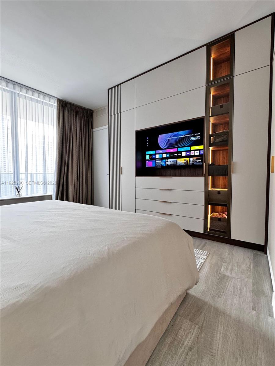 45 Southwest 9th Street, Unit 2303 Miami, FL 33130 - Photo 15 of 33 a bedroom with a bed and a flat screen tv