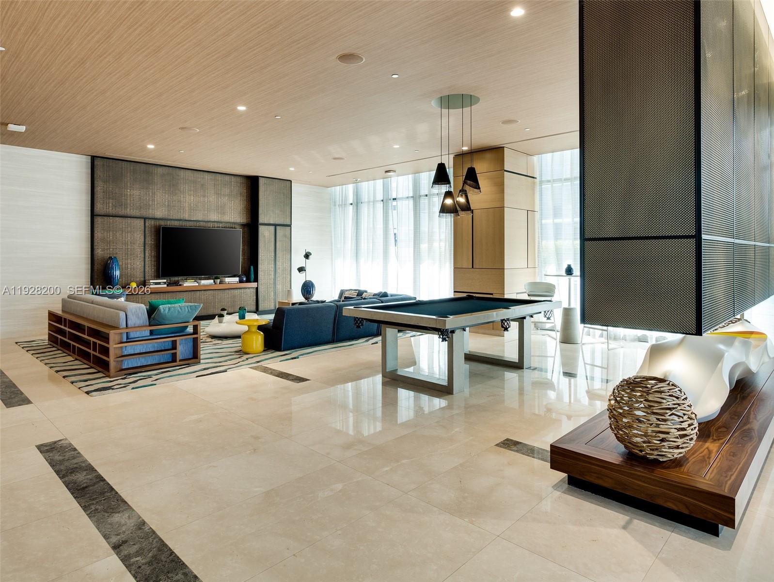 45 Southwest 9th Street, Unit 2303 Miami, FL 33130 - Photo 21 of 33 a living room with furniture and a flat screen tv