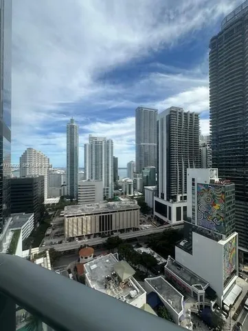 a view of a patio with couches table and chairs and potted plants