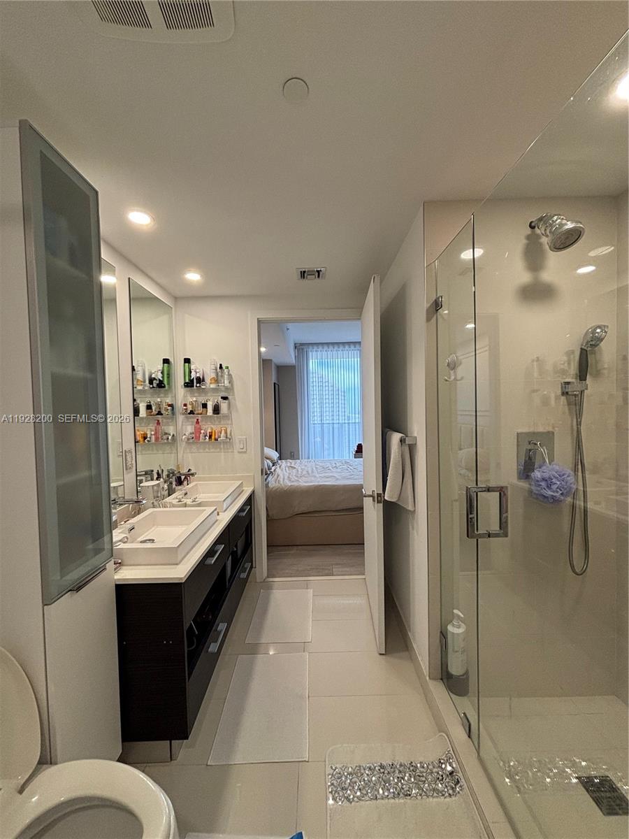 45 Southwest 9th Street, Unit 2303 Miami, FL 33130 - Photo 10 of 33 a bathroom with a bathtub shower sink and toilet