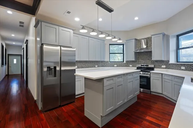 a bathroom with a granite countertop sink mirror vanity and toilet