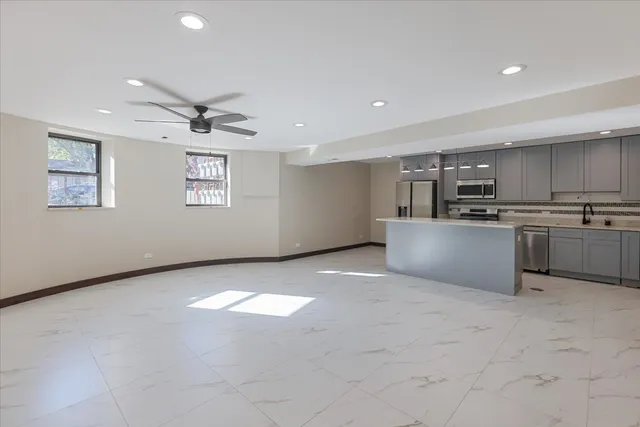 a picture of a room that has a window and a potted plants