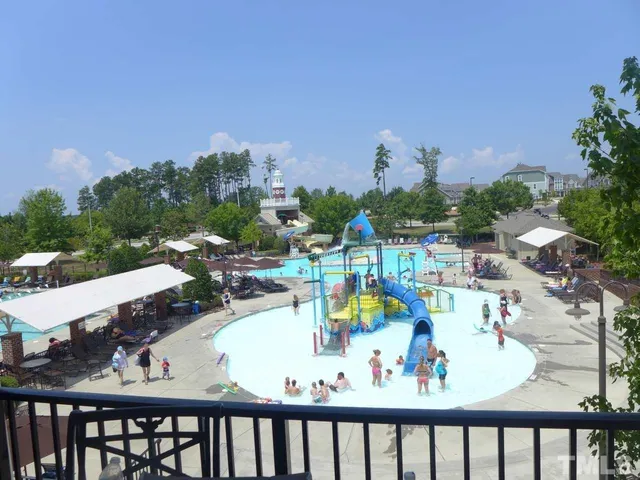 an aerial view of a house with yard and mountain view in back