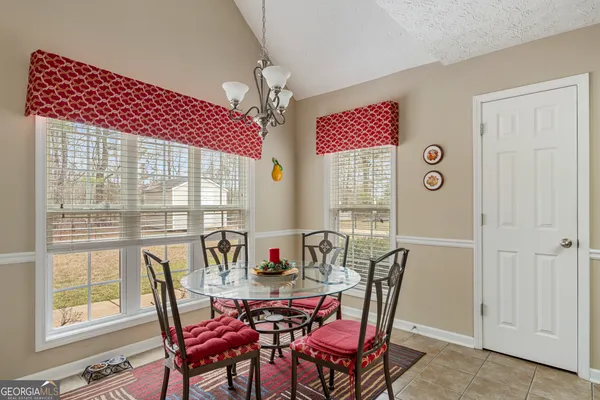a view of a dining room with furniture window and outside view