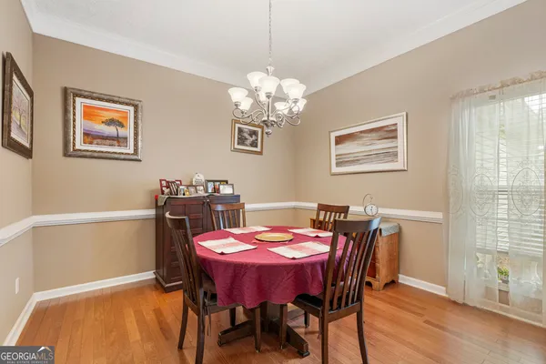 a view of a dining room with furniture window and wooden floor