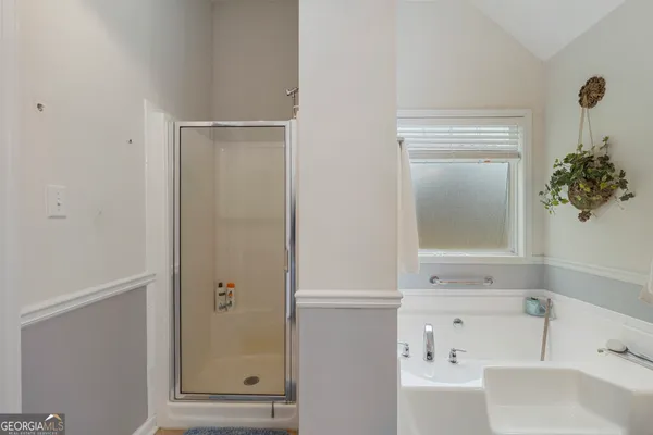 a bathroom with a bathtub and a shower