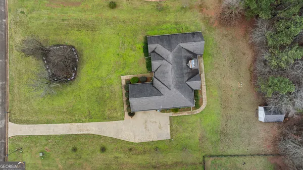an aerial view of a house with a yard