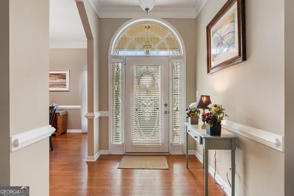 a view of a hallway with wooden floor and workspace