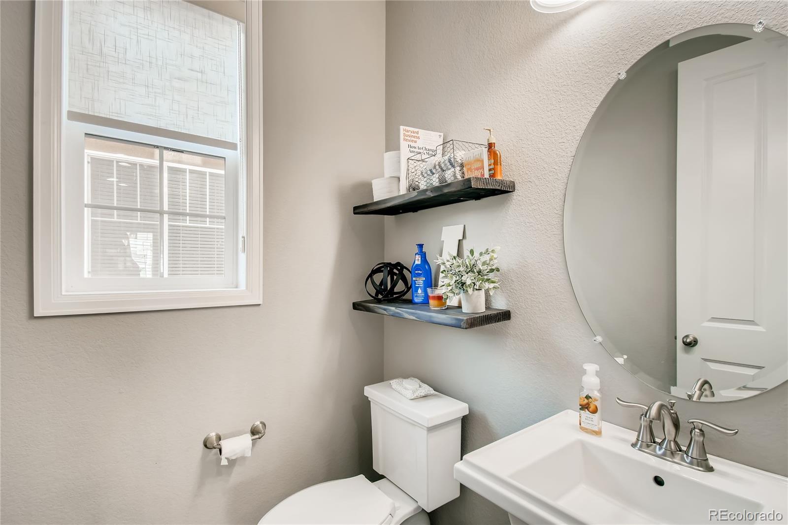 14402 Double Dutch Circle Parker, CO 80134 - Photo 13 of 31 a bathroom with a toilet sink and mirror