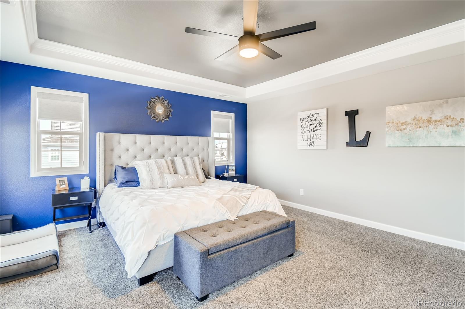 14402 Double Dutch Circle Parker, CO 80134 - Photo 15 of 31 a bedroom with a bed chandelier and a window