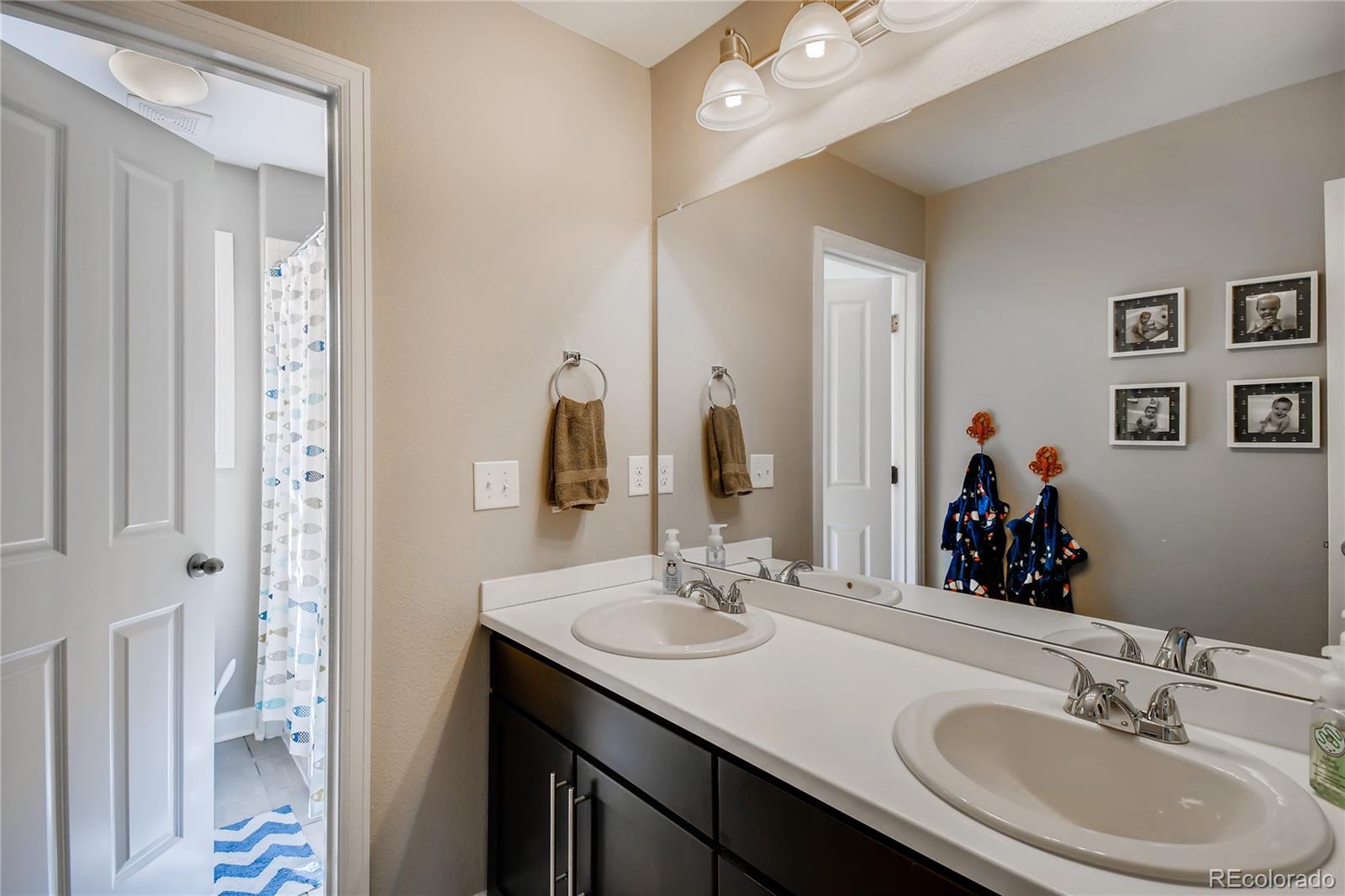 14402 Double Dutch Circle Parker, CO 80134 - Photo 20 of 31 a bathroom with a double vanity sink mirror and double