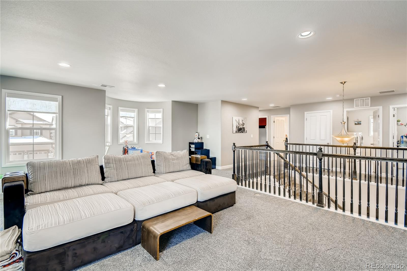 14402 Double Dutch Circle Parker, CO 80134 - Photo 21 of 31 a spacious bedroom with a bed and a large window