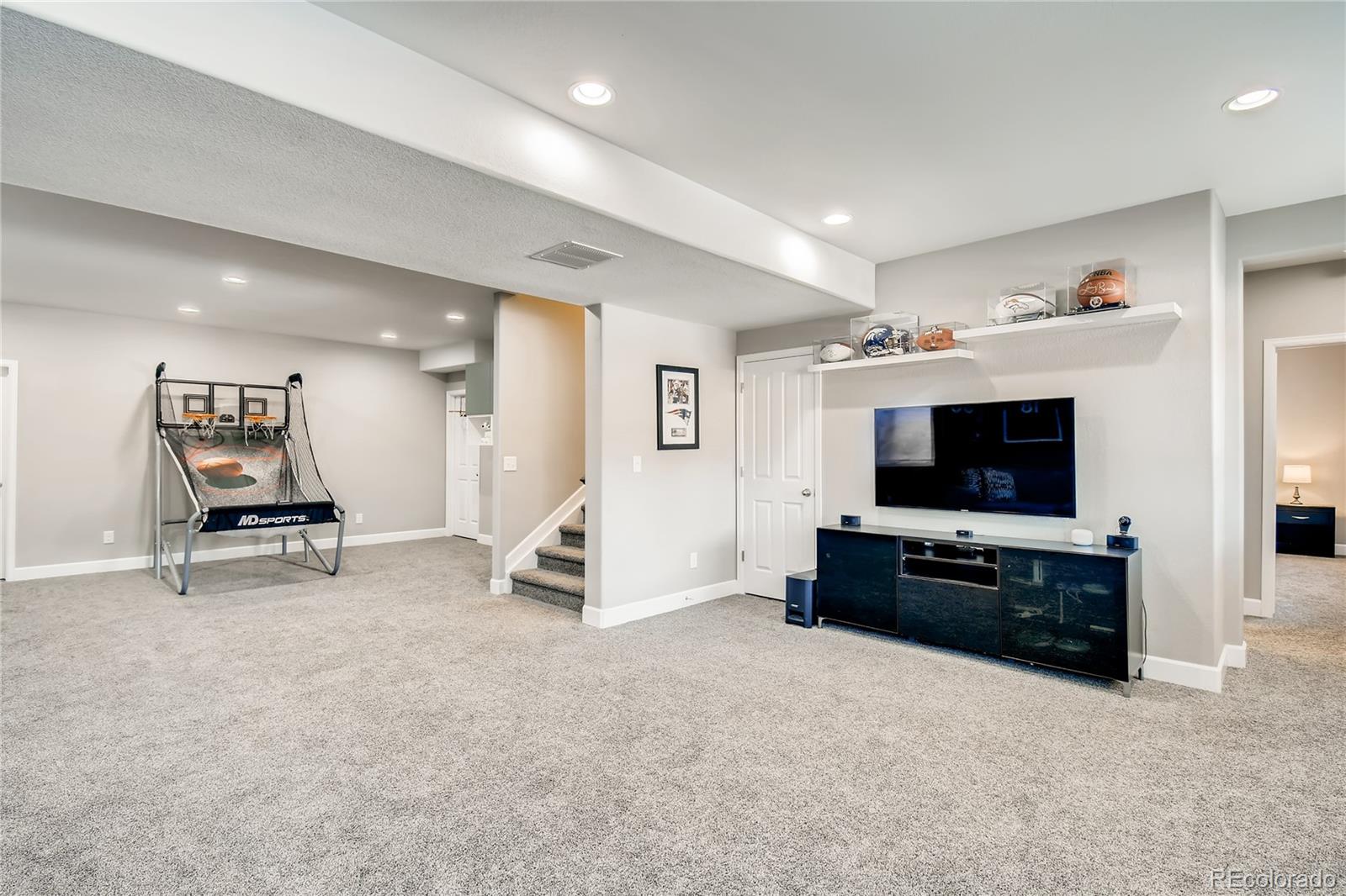 14402 Double Dutch Circle Parker, CO 80134 - Photo 22 of 31 a living room with furniture and a flat screen tv