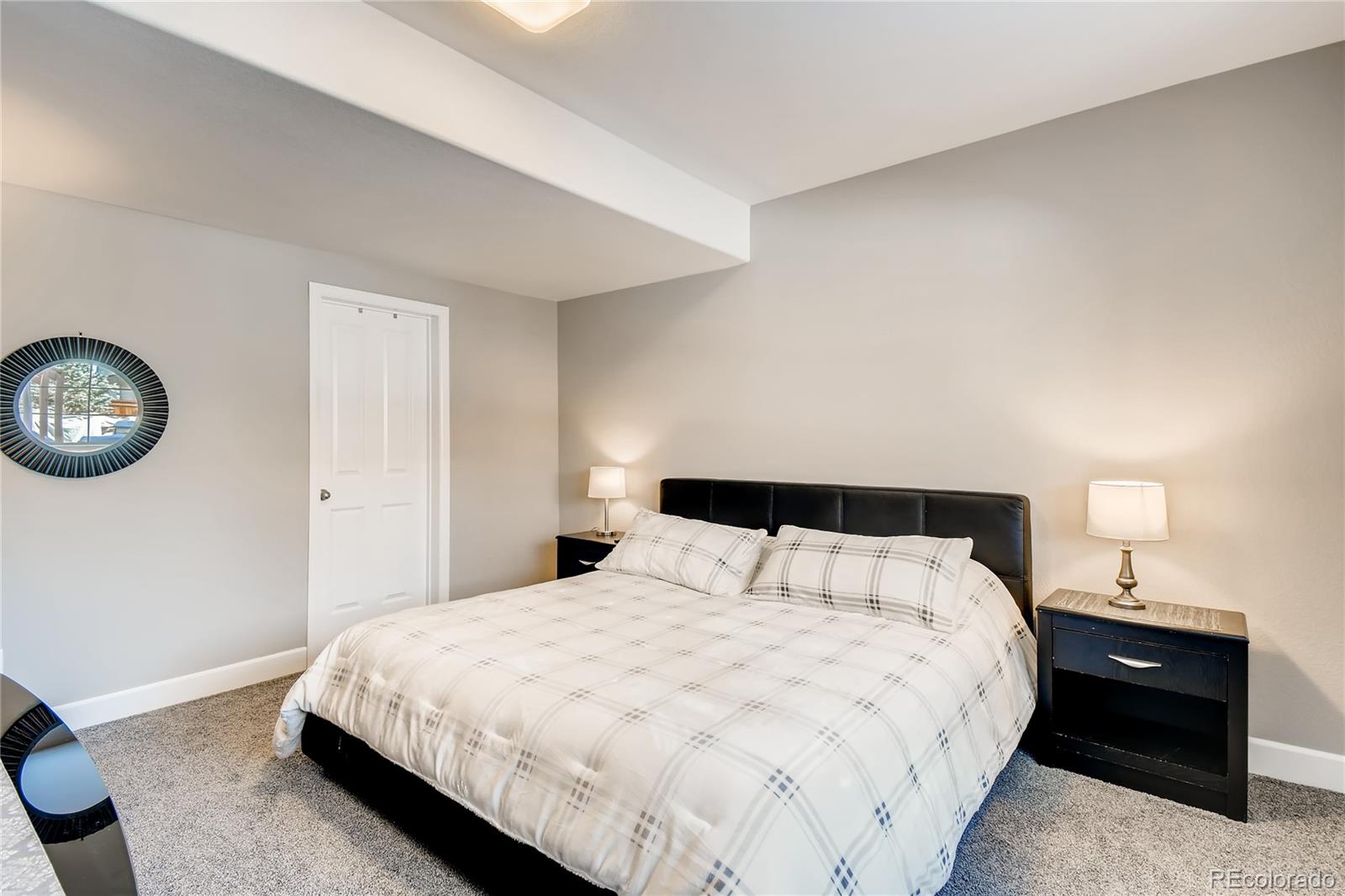 14402 Double Dutch Circle Parker, CO 80134 - Photo 23 of 31 a bedroom with a bed and a lamp