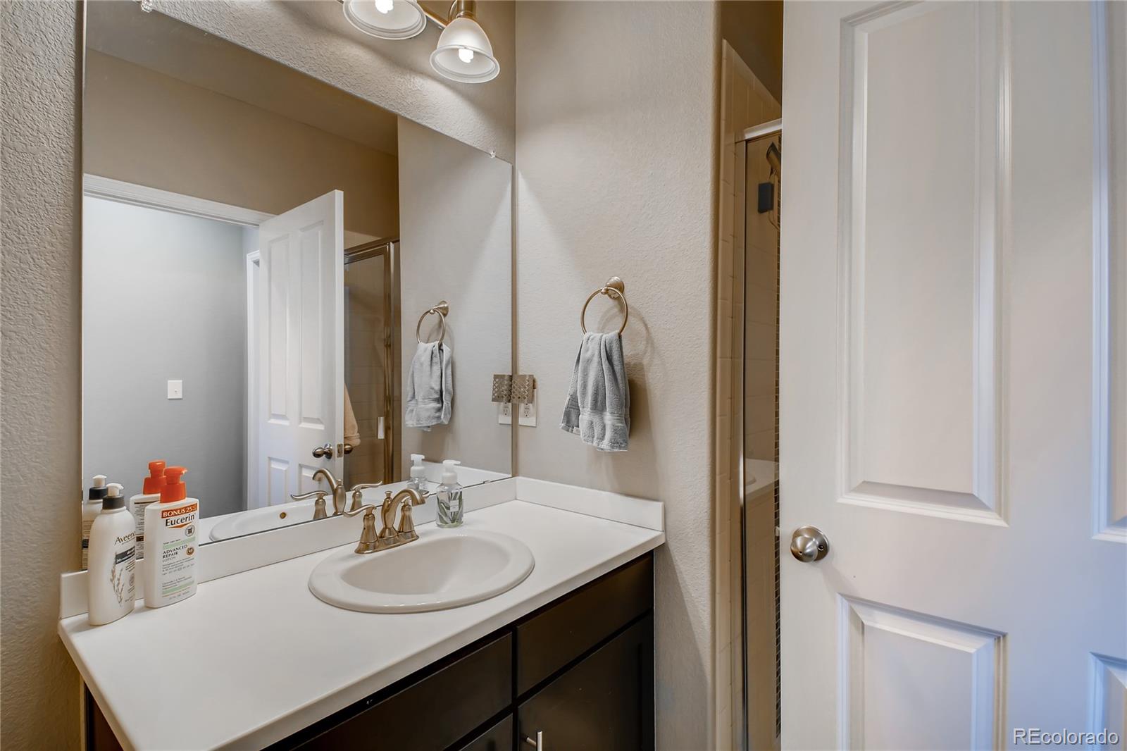 14402 Double Dutch Circle Parker, CO 80134 - Photo 24 of 31 a bathroom with a sink vanity and a mirror