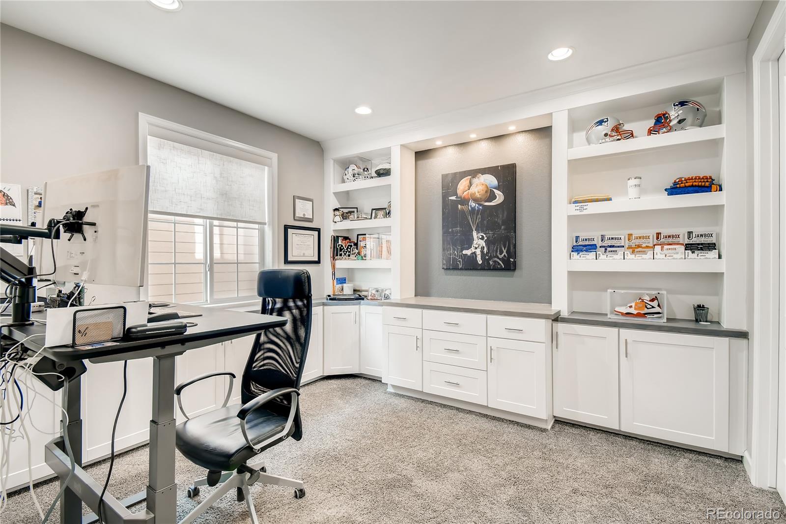 14402 Double Dutch Circle Parker, CO 80134 - Photo 6 of 31 a hall with cabinets a window and a painting on the wall