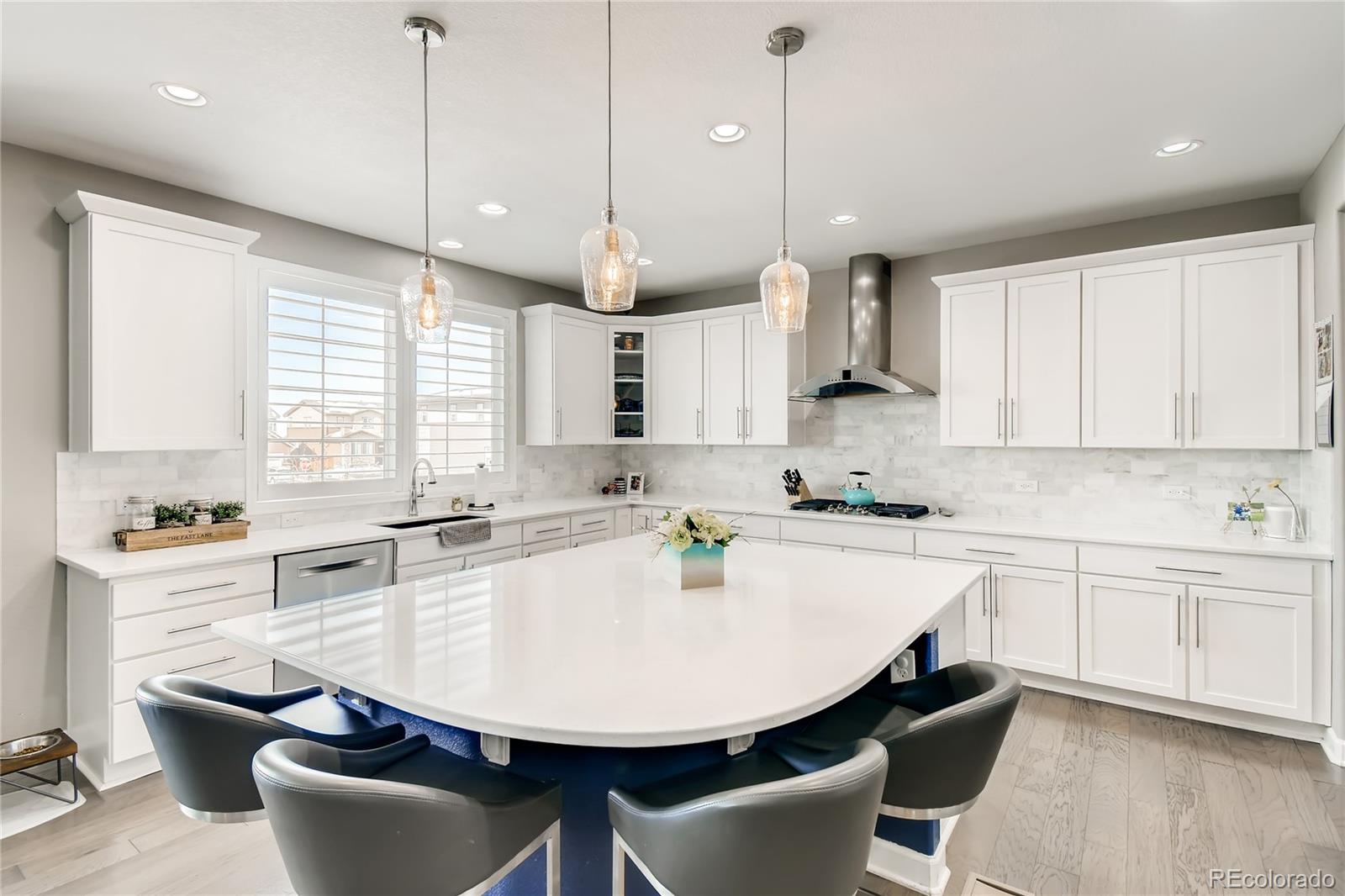 14402 Double Dutch Circle Parker, CO 80134 - Photo 8 of 31 a kitchen with stainless steel appliances a stove a sink a window and chairs