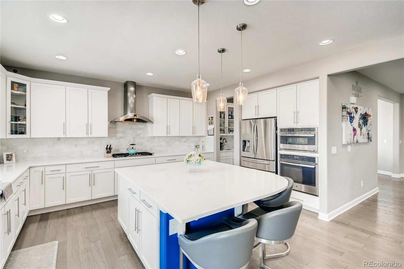 14402 Double Dutch Circle Parker, CO 80134 - Photo 9 of 31 a kitchen with stainless steel appliances a stove a sink a kitchen island and chairs