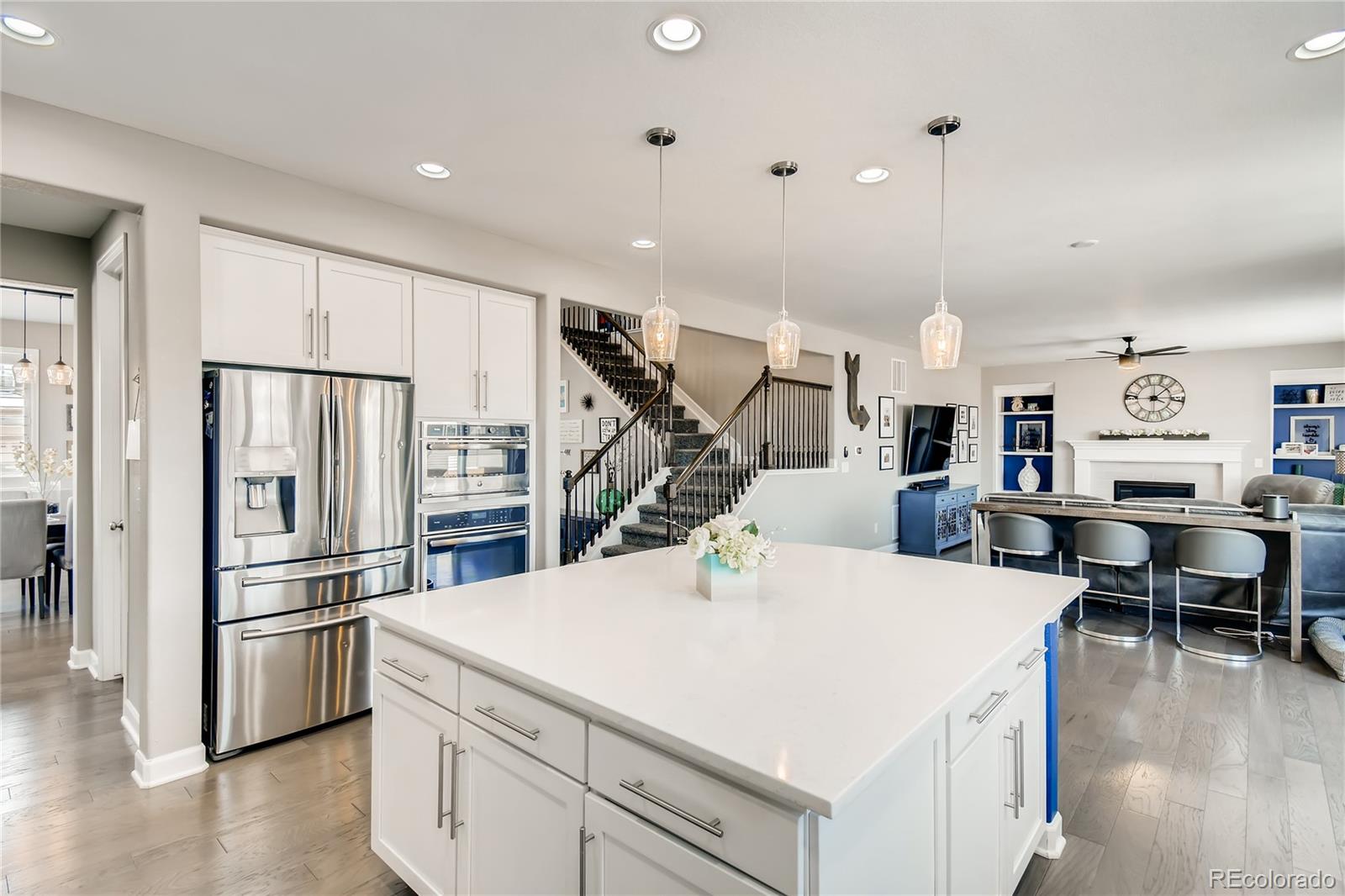 14402 Double Dutch Circle Parker, CO 80134 - Photo 10 of 31 a kitchen with stainless steel appliances kitchen island a refrigerator and a stove top oven