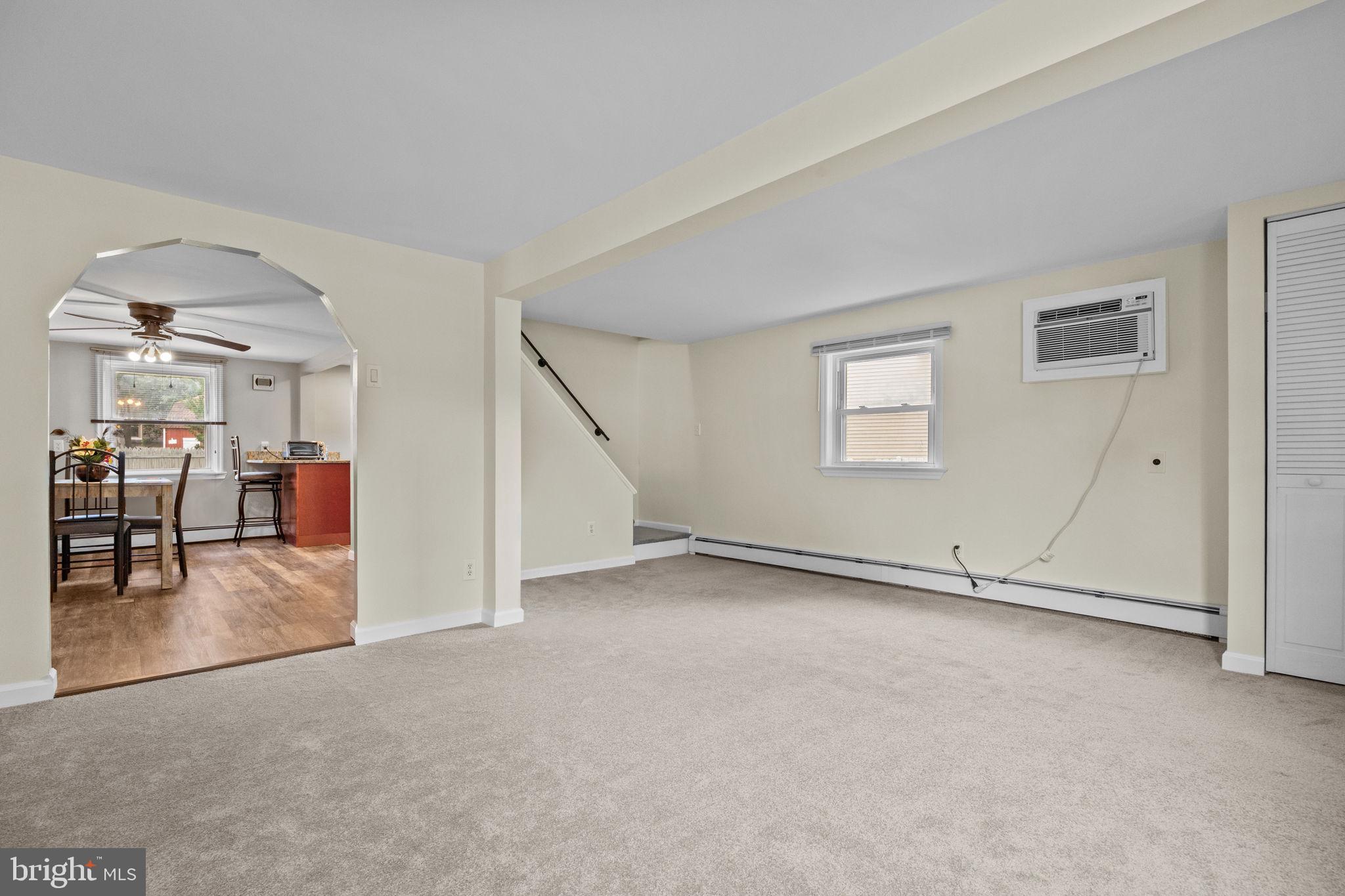 222 Neshaminy Road Croydon, PA 19021 - Photo 5 of 39 an empty room with fireplace and windows