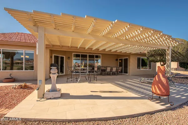 a view of a house with backyard outdoor seating area