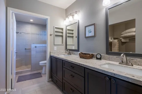 a bathroom with a granite countertop sink mirror and double