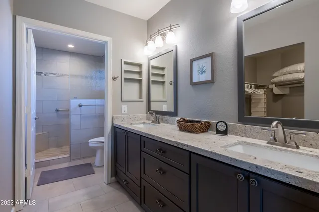 a bathroom with a granite countertop sink mirror and double
