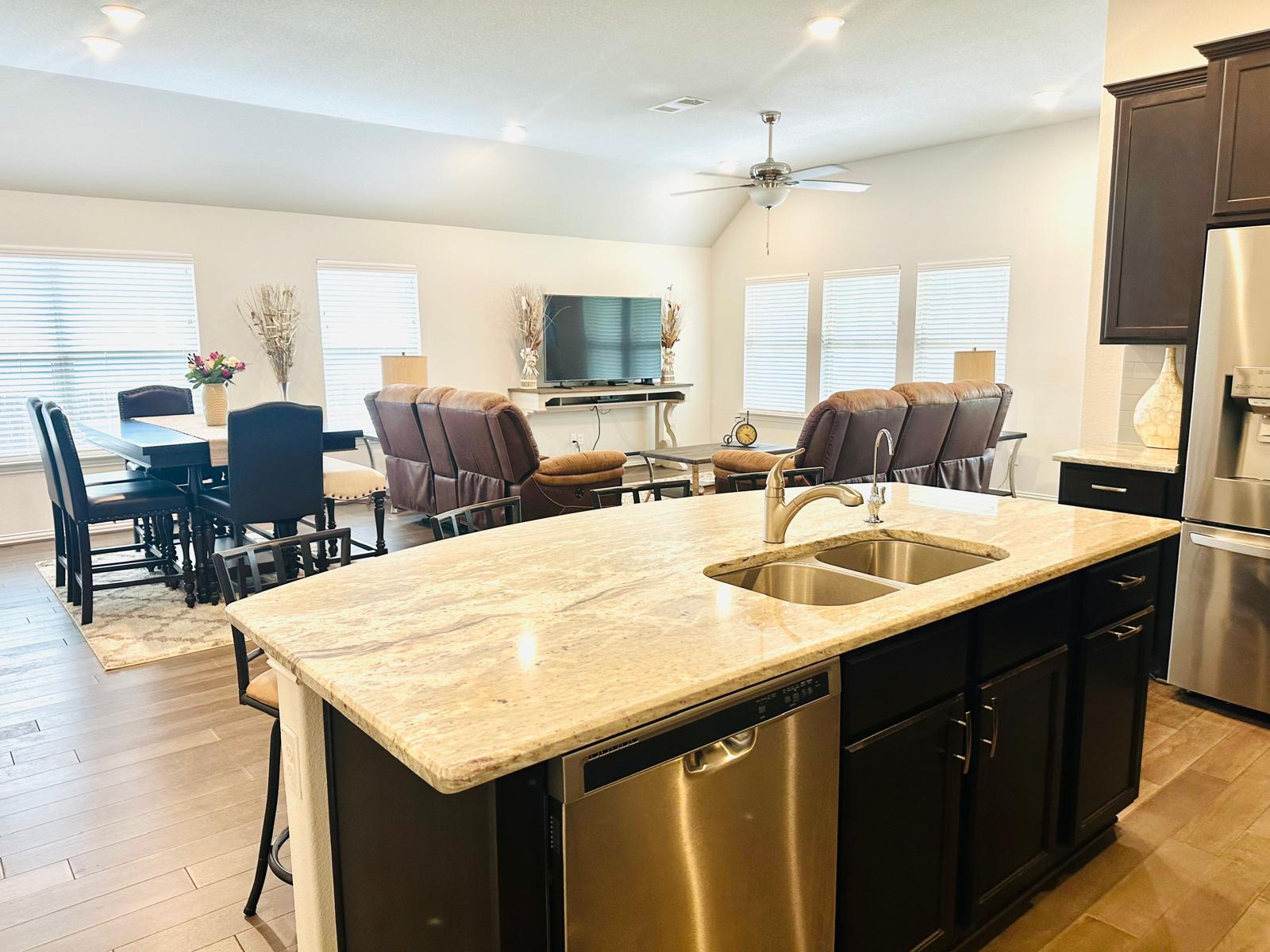 862 Leadtree Loop Buda, TX 78610 - Photo 17 of 40 a kitchen with center island table and chairs