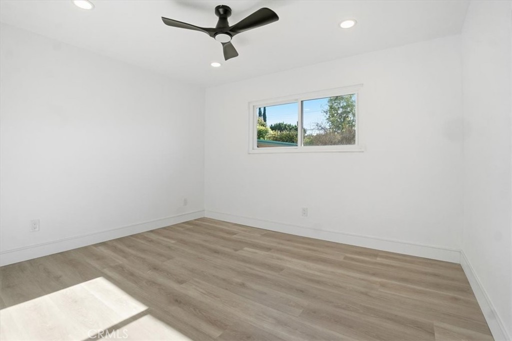 1410 Pleasant View Drive Redlands, CA 92374 - Photo 30 of 44 an empty room with wooden floor and windows
