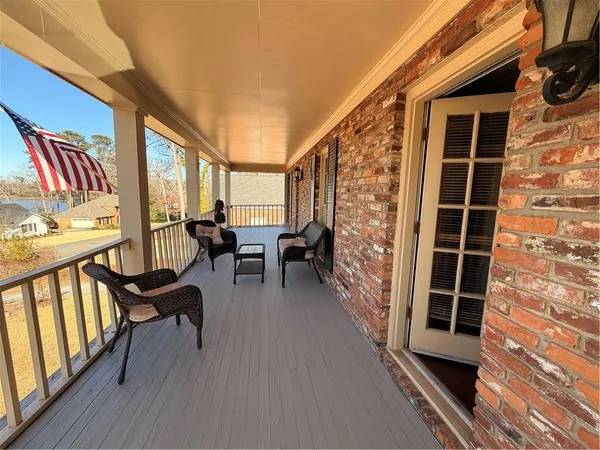 a view of balcony with chairs and wooden floor