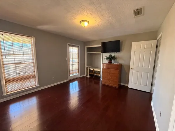 a living room with hard wood floors and a window