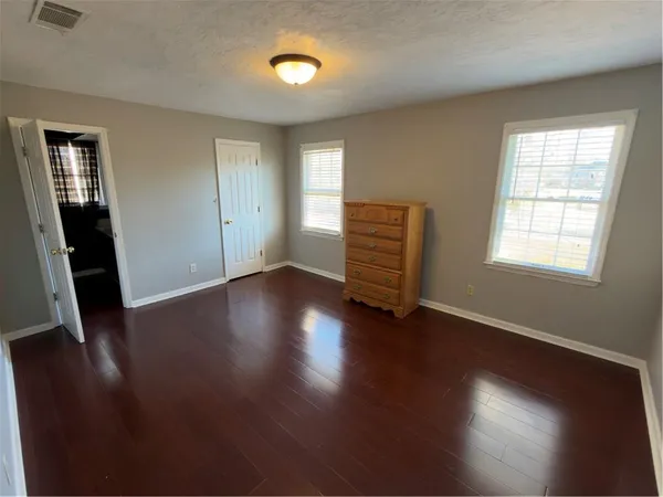 a view of room with hardwood floor and window