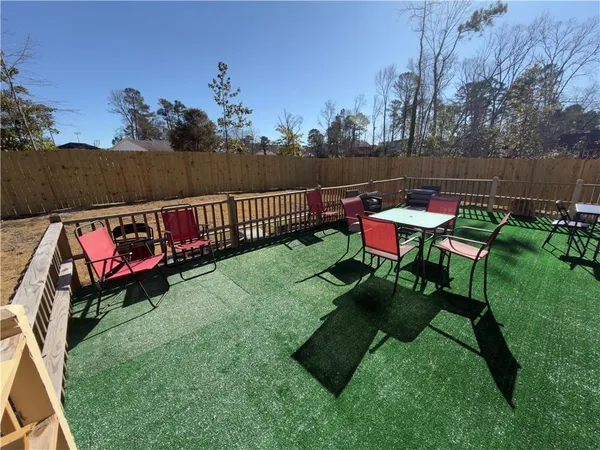 a view of a chairs and table in the grass