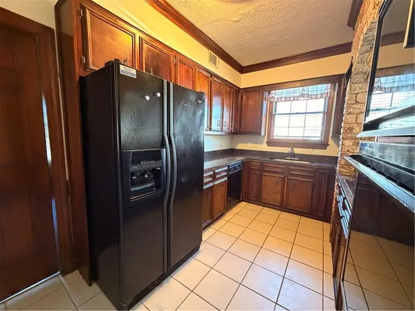 a kitchen with stainless steel appliances granite countertop a refrigerator a sink a stove and island