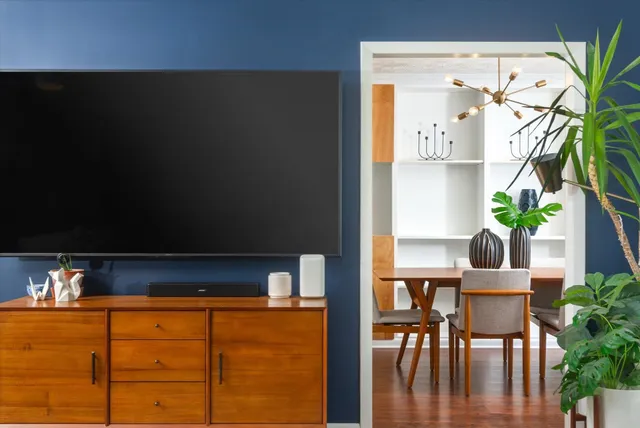 a kitchen with stainless steel appliances granite countertop wooden cabinets a sink and dishwasher with wooden floor