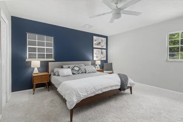 a bedroom with a bed and flat screen tv