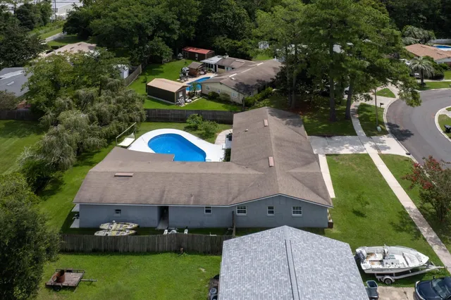 an aerial view of a house with a yard